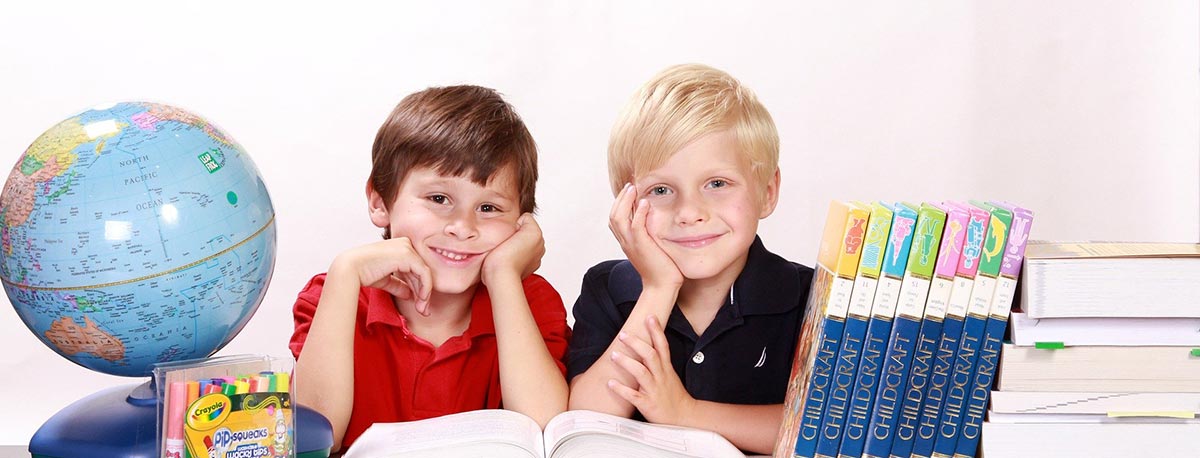 two boys with educational materials